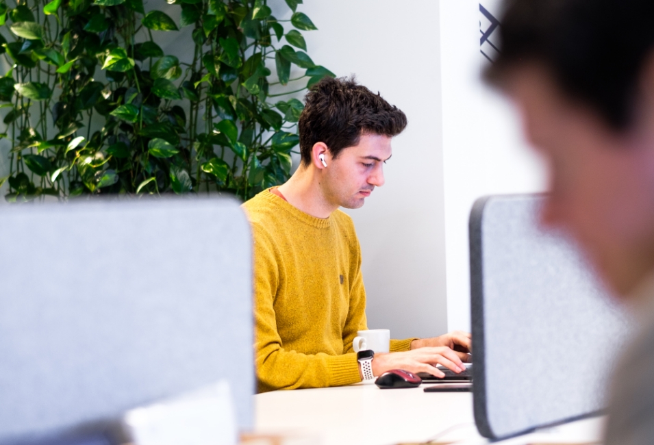Man sat at a computer working in an office